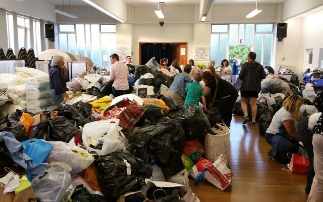 Volunteers sort through items donated to the Grenfell fire relief effort