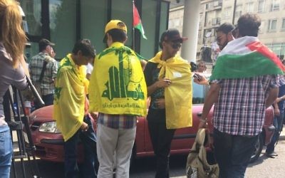 Young men proudly wear the Hezbollah terror flag in central London without fear of arrest.