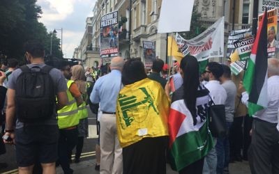 Pro-Palestine supporters draped in Hezbollah flags at Sunday's Al Quds Day march