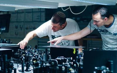Prof. Hagai Eisenberg and graduate student Daniel Istrati study a single photon experiment at the Hebrew University's Quantum Information Science Center. (Credit: Yitz Woolf for Hebrew University)