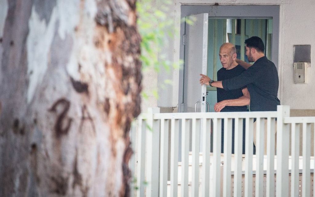 Former Israeli Prime Minister Ehud Olmert, left, exits prison after his sentence, in Ramle, Israel, Sunday, July 2, 2017. The parole board of Israel's Prison Service has granted Olmert early release from prison. Prison Service spokesman Assaf Librati says the board granted Olmert's request to reduce a third of his 27-month incarceration sentence.

Photo by: JINIPIX