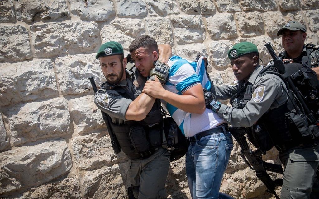 Muslim worshippers  detained by Israeli forces after protesting  outside the Temple Mount, in Jerusalem's Old City. 

Photo by: JINIPIX
