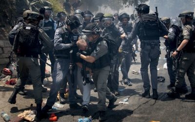 Israeli police clash detaining Palestinian protesters in the East Jerusalem neighbourhood of Wadi el Joz, outside Jerusalem's Old City, following Friday prayers on July 21, 2017. 

Photo by: JINIPIX