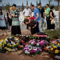 Friends and relatives mourn at the graves of Yosef Salomon (70), his daughter Haya (46) and son Elad (35), after their funeral, attended by thousands, at the Modiin Cemetery, on July 23, 2017. 


Photo by: JINIPIX