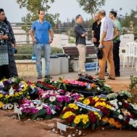 Friends and relatives mourn at the graves of Yosef Salomon (70), his daughter Haya (46) and son Elad (35), after their funeral, attended by thousands, at the Modiin Cemetery, on July 23, 2017. 


Photo by: JINIPIX
