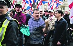 Britain First and EDL (English Defence League) protesters walk along Northumberland Avenue during a demonstration in London. Britain First and EDL (English Defence League) protesters walk along Northumberland Avenue during a demonstration in London.