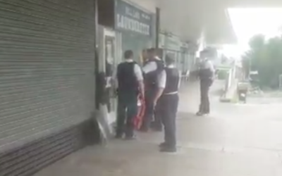 Police detaining the man in Hendon, after he brandished knives outside a synagogue