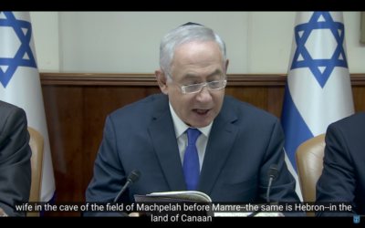 Benjamin Netanyahu wears a kippah as he reads a passage of the bible during a weekly cabinet meeting