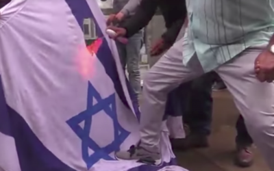An Israeli flag being set on fire in the heart of Central London