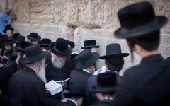 Jewish men pray as they gather for the ritual of Tisha B'Av at the Western Wall in the Old City of Jerusalem,

Photo by: JINIPIX