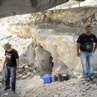 Employees of the Israel Antiquities Authorities (IAA) work during archaeological excavations in a newly discovered small cave at the Arab town of Reina in Galilee.
