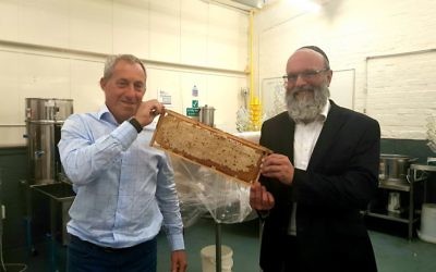 Honeymaker, Warren Bader (l) having his kosher credentials checked by a member of the KLBD