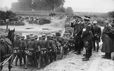 Hitler watching German soldiers marching into Poland in September 1939.