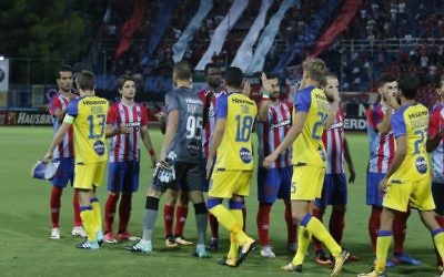 Players from Panionios and Maccabi Tel Aviv line-up ahead of last week's kick-off - including Iranian Ehsan Hajsafi (number 28 in striped shirt). Picture: MTA