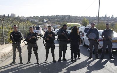 Israeli police blocks the road to Har Adar settlement near Jerusalem after Nimr Mahmoud Ahmed Jamal, a Palestinian attacker opened fire at the entranc killing three Israeli men and critically wounding a fourth.

 (AP Photo/Mahmoud Illean)
