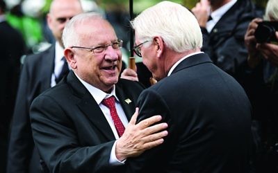 Israel's President Rivlin (left) embraces his German counterpart Frank-Walter Steinmeier (right) in Munich