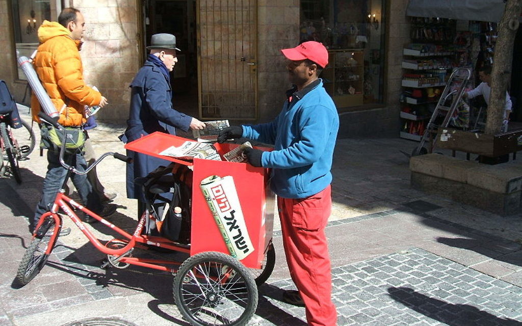 Distributing copies of the free daily Hebrew newspaper "Israel HaYom" in Jerusalem

Source: Wikimedia Commons