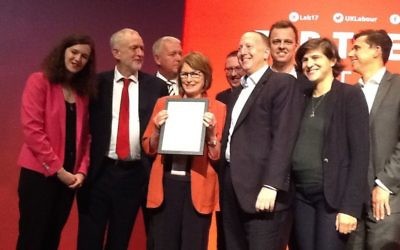 Labour leader Jeremy Corbyn (second left) presenting an award to JLM in 2017