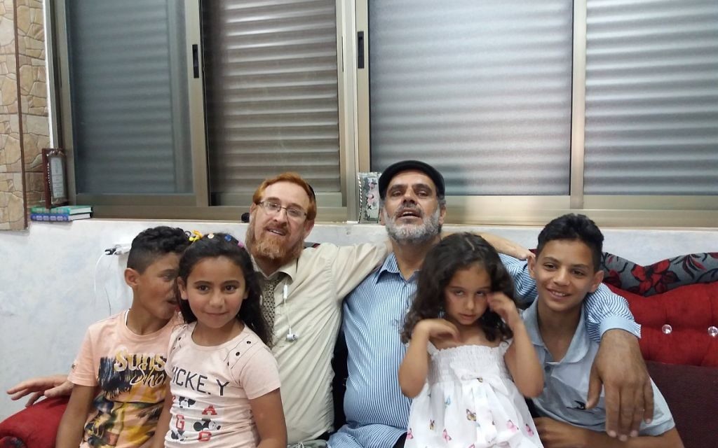 Likud Party MK Yehuda Glick with Muhammad Sabir Jabir and his family in his Hebron  home