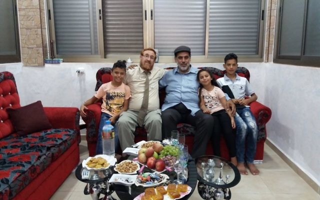 Likud Party MK Yehuda Glick with Muhammad Sabir Jabir and his family in his Hebron  home