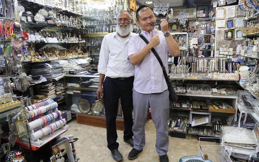 Let's Talk Business participants engaging with Jewish traditions in a shop Let's Talk Business participants engaging with Jewish traditions in a shop