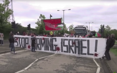 Protesters hold banners and shout 'stop arming Israel' at the demonstration 

Photo source: Youtube video by RT