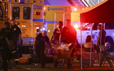 A wounded person is walked in on a wheelbarrow as Las Vegas police respond during an active shooter situation on the Las Vegas Stirp in Las Vegas on Sunday

(Chase Stevens/Las Vegas Review-Journal via AP)