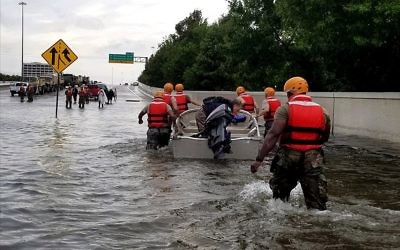 Soldiers with the Texas Army National Guard move through flooded Houston streets to combat rising floodwaters from Hurricane Harvey