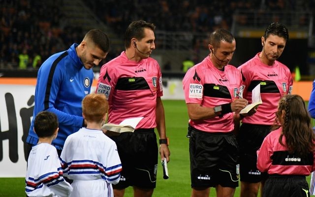 Inter Milan captain Mauro Icardi signs a copy of Anne Frank's diary for a mascot ahead of their side's game against Sampdoria