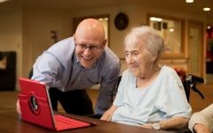 A Jewish Care resident learning how to stay connected digitally with Pawel Moczulewski, Manager of the Living Well team

Credit: Blake Ezra Photography