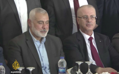 Hamas leader Ismail Haniyeh  (left) with Rami Hamdallah (right) during a cabinet meeting in Gaza 

Source: Screenshot from Al Jazeera video