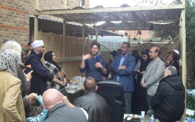 Rabbi Natan Levy explains Succot to worshippers of Al Manaar Mosque, standing next to their chief executive, Abdurahman Sayed