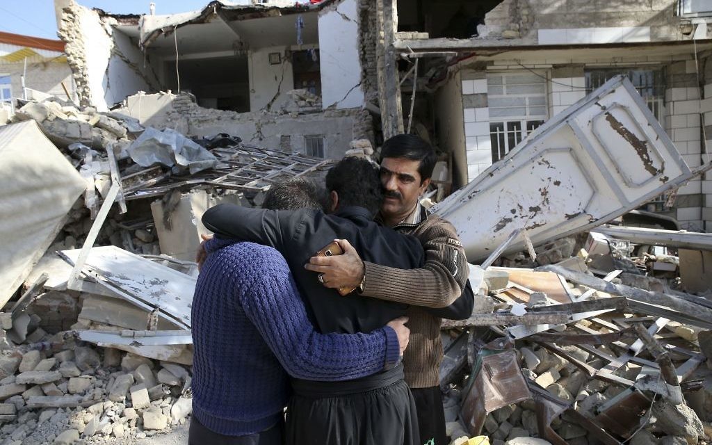 Earthquake survivors mourn in front of destroyed houses in Sarpol-e-Zahab in western Iran,

Survivors are waiting for badly needed aid, three days after a powerful earthquake along the Iraq border killed hundreds and left thousands injured. 

(AP Photo/Vahid Salemi)