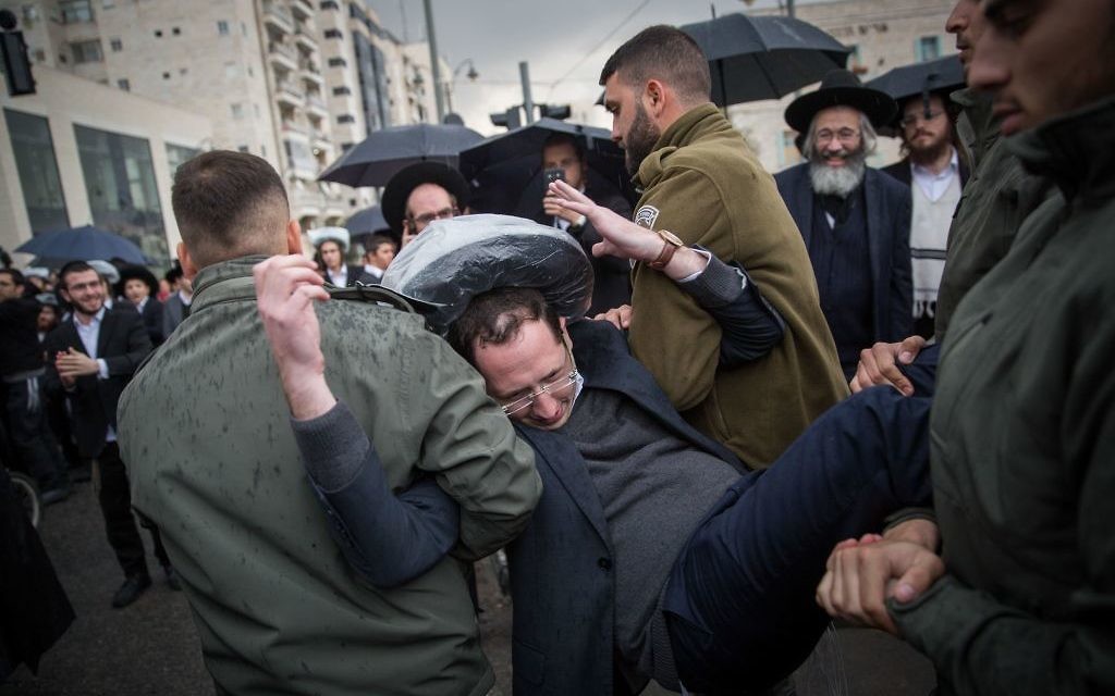 Charedi Jews being taken away by police in Jerusalem during a protest over army service.