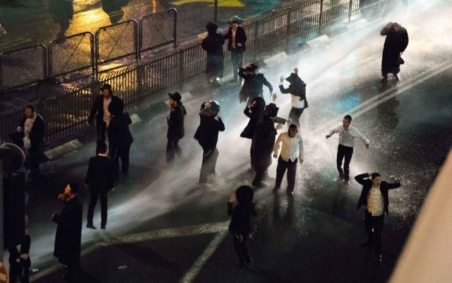 Charedi Jews being targeted with water cannons in Jerusalem during a protest