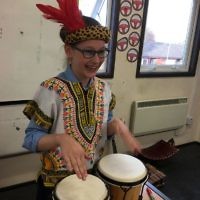 A student at Keser Torah in Gateshead with a drum instrument