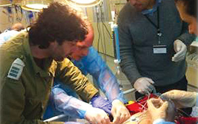 Israeli medical staff treating seriously injured Syrian children. Their identity is hidden for their own safety as those seeking Israeli help are often targeted. The individuals pictured do not feature in the documentary Love Your Enemies