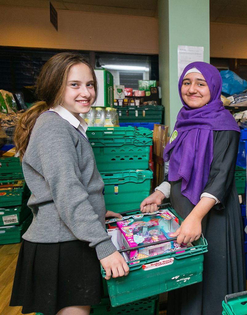 Muslim and Jewish pupils from JCOSS and Lady Nafisa schools working in the warehouse for charity Sufra - picture by Yakir Zur