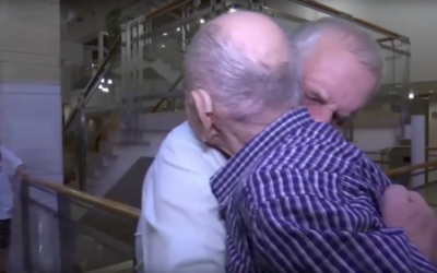 Eliahu Pietruszka embraces 66-year-old Alexandre, a nephew he never knew he had, who flew from Russia to see him.