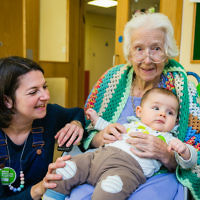 Three generations meet as Apples and Honey Nursery visit Nightingale House care home in Wimbledon - picture by Yakir Zur