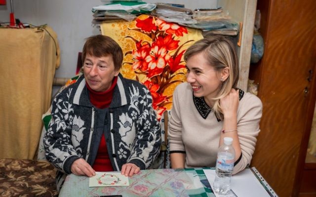 Valentina (L) receives support from World Jewish Relief and sits alongside World Jewish Relief staff member Katya Roshchyna (R) during a visit to her home