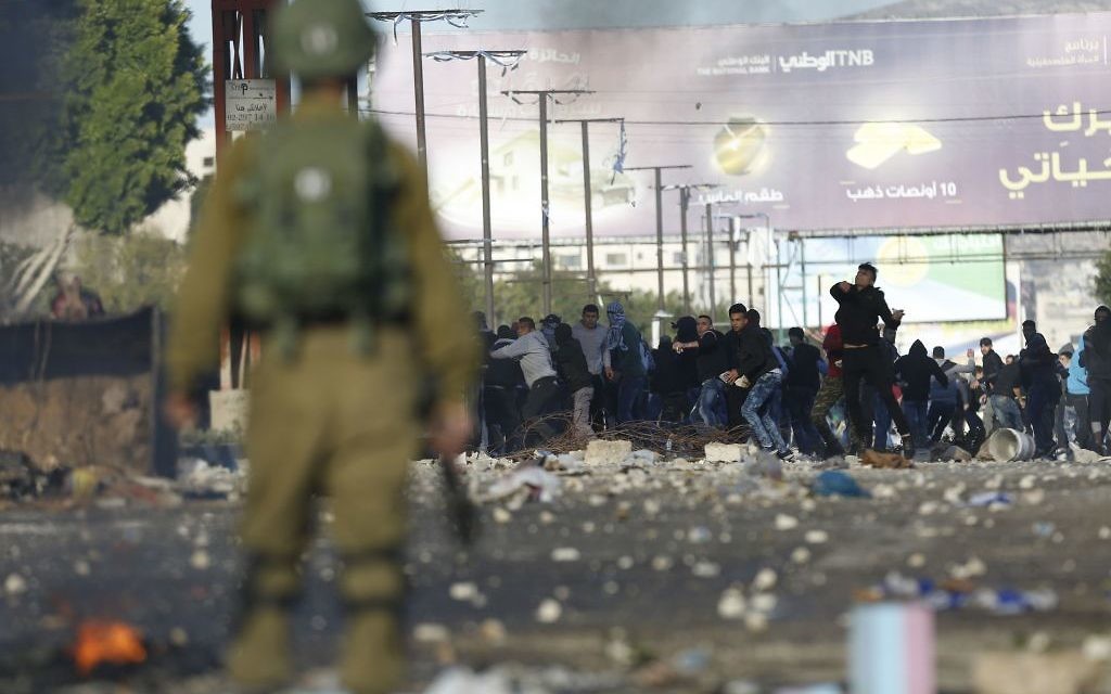 Palestinians clash with Israeli troops during a protest l in the West Bank City of Nablus,, Dec. 2017. (AP Photo/Majdi Mohammed)