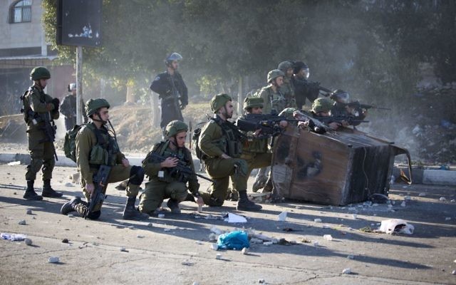 Israeli soldiers take position during clashes with at Palestinians in the West Bank City of Nablus. (File image).