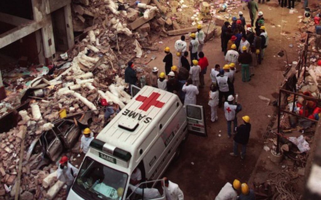 Firefighters and rescue workers search through the rubble of the Buenos Aires Jewish Community centre in  July 1994.