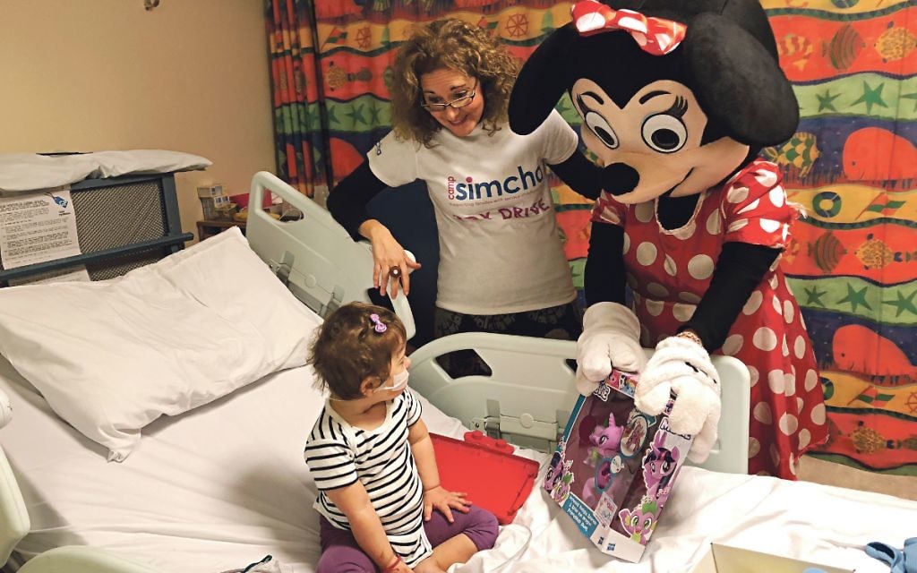 Minnie Mouse helps brighten up the day of a young patient in Barnet Hospital's Galaxy ward