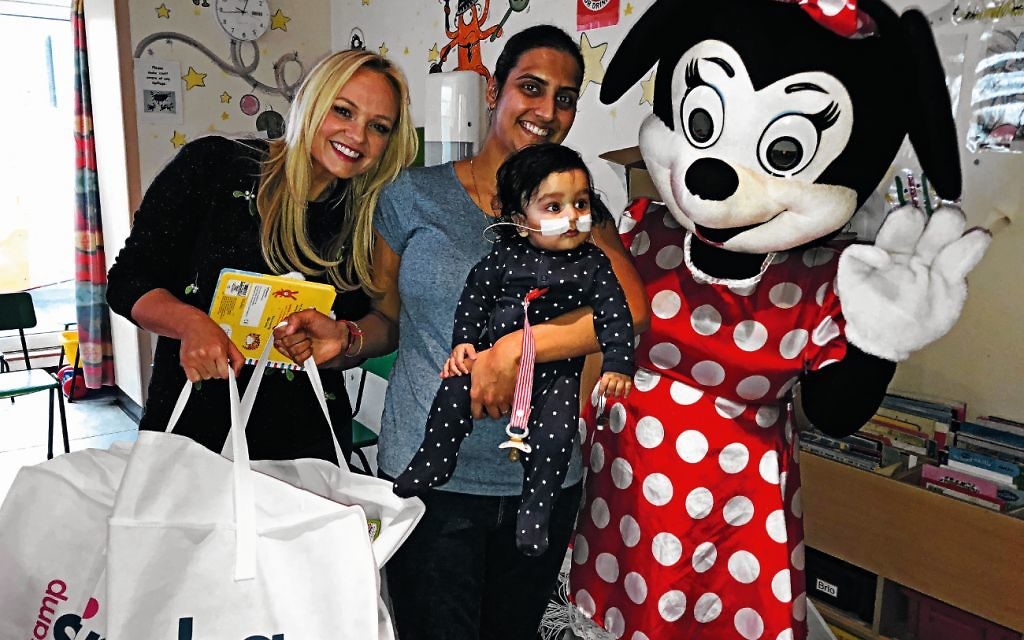 Emma Bunton and Minnie Mouse meet a young patient during a Camp Simcha event