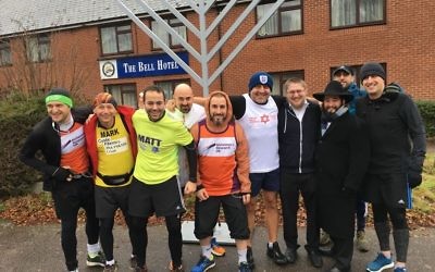 The dads at the start of the half-marathon in front of the Epping menorah