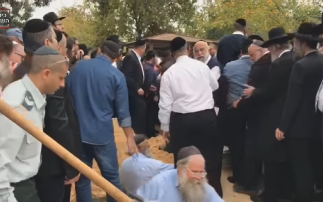 Thousands of mourners gathered in Israel on Wednesday for the funerals of a mother and three children killed in a house fire (Screenshot from Youtube)
