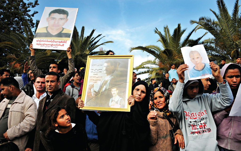 Tunisians celebrate of the first anniversary of the popular uprising that toppled their long-standing dictator and unleashed the Arab Spring