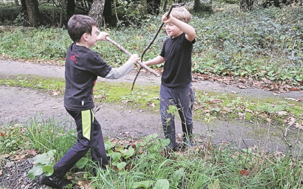 The boys enjoy a stick fight in Sherwood Forest